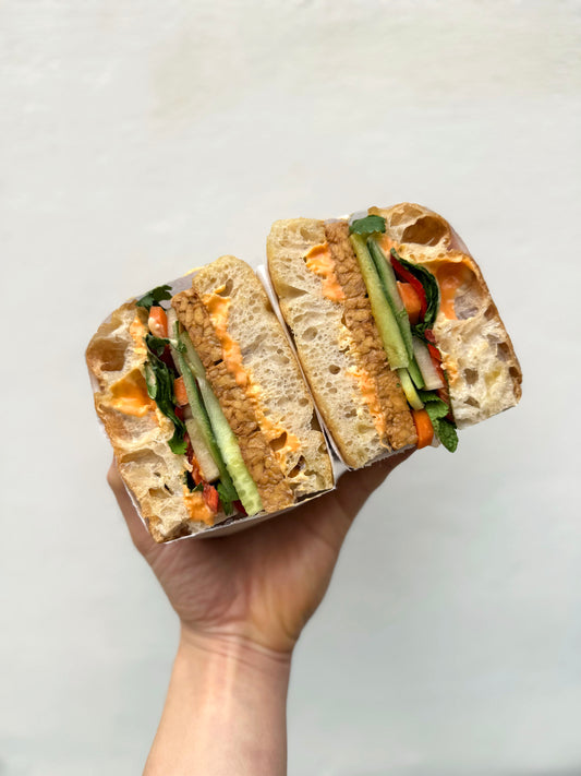 Focaccia 'sammich': Banh Mi with tempeh, sriracha mayo, daikon, carrot and chilli pickle, cucumber, coriander, mint.